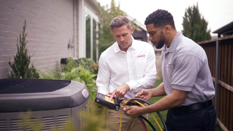 Techs discussing an hvac unit