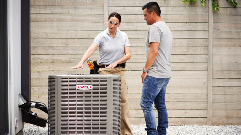 Tech discussing the size of an HVAC unit with homeowner