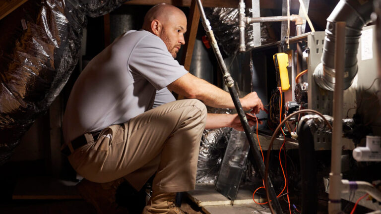 tech performing maintenance on a furnace