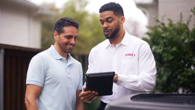 Tech explaining maintenance plan with homeowner