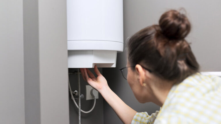 woman inspecting water heater