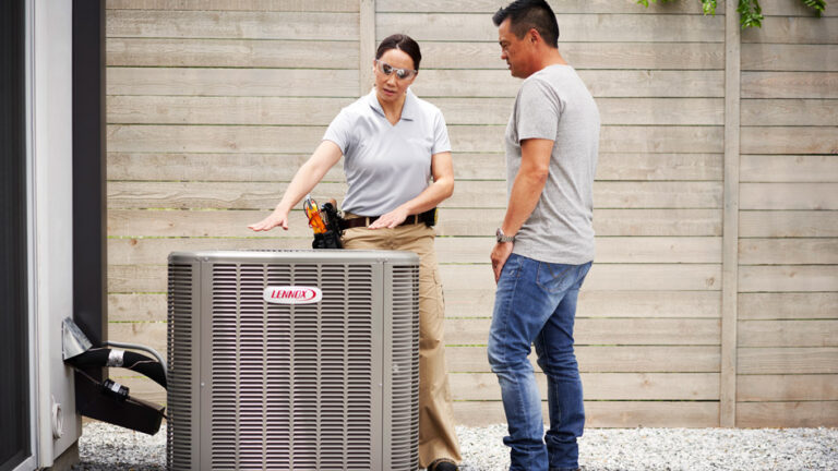 tech and homeowner discussing Lennox HVAC unit