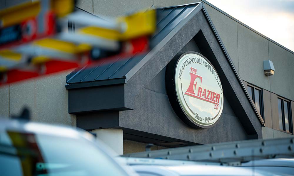 The Frazier Building behind their fleet of trucks