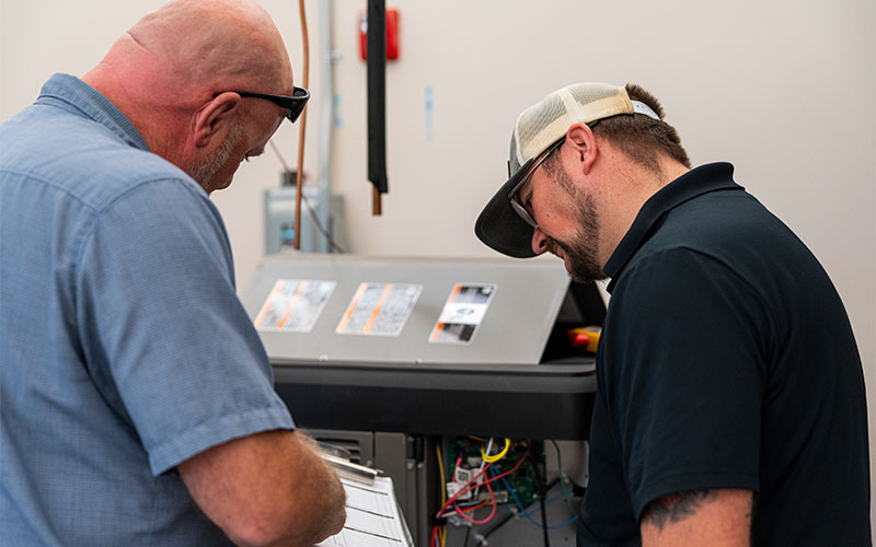 Frazier tech discussing what maintenance needs to be completed on an hvac unit