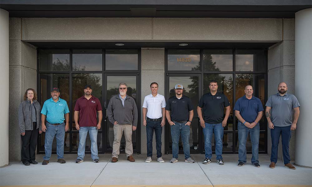 Team members in front of office building
